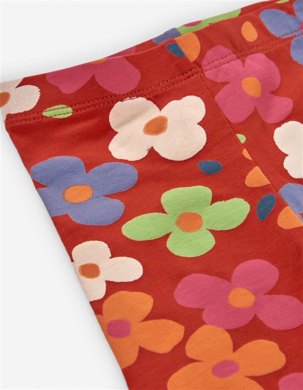 Leggings flores coloridas em fundo terracota